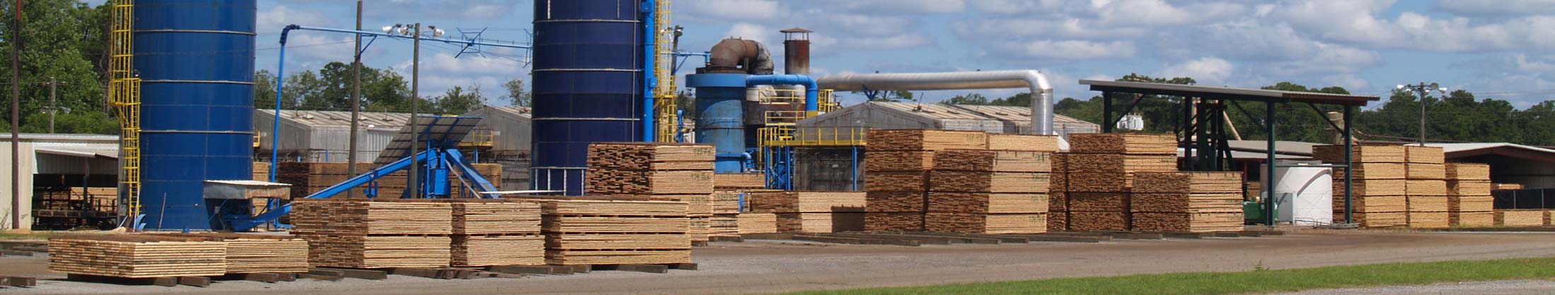 A sawmill yard, packs of milled softwood stacked under the headrig