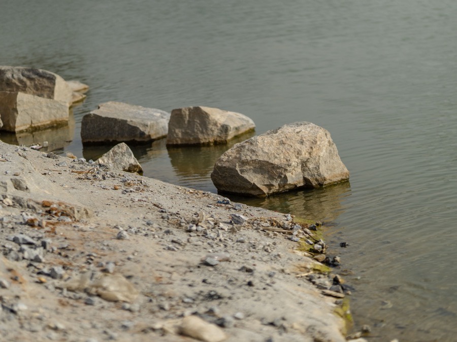 Graded stone armouring the edge of a shoreline where it meets the water
