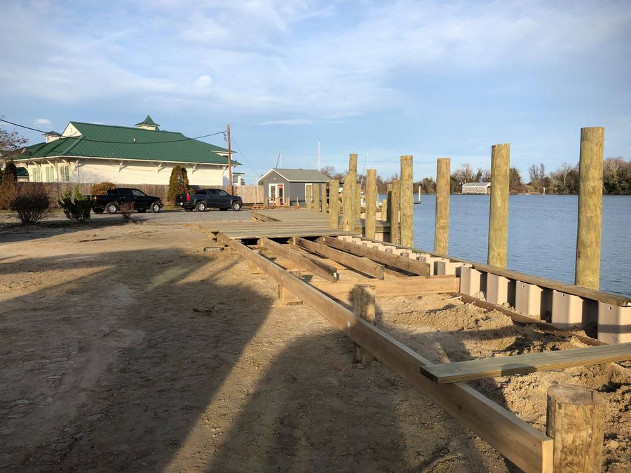 Sheet pile bulkhead under construction at Urbanna Marina, timber walers bolted along the sheets and pilings driven behind