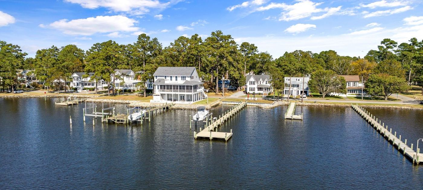 Row of waterfront homes along a channel, each with its own dock and boat slip